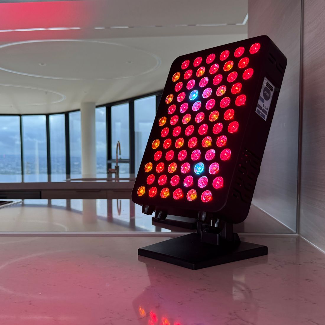 HUVE LUMA Glow Red Light Therapy Panel in Black on a stone benchtop