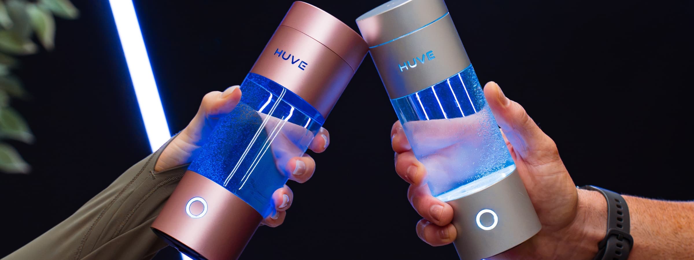 Two people toasting with HUVE Perform hydrogen water bottles