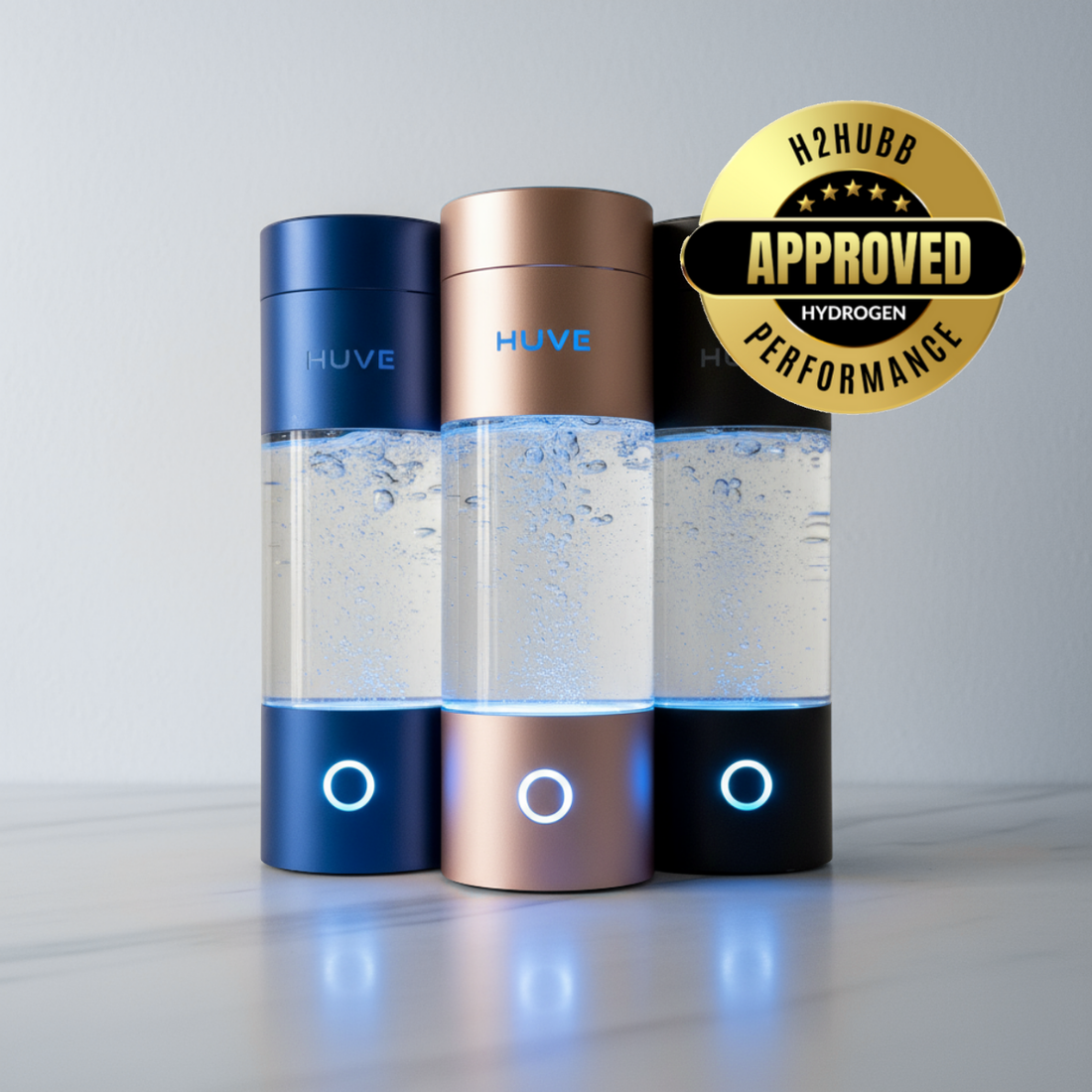 three huve perform hydrogen water bottles in blue, pink, and black with H2HUBB approved logo