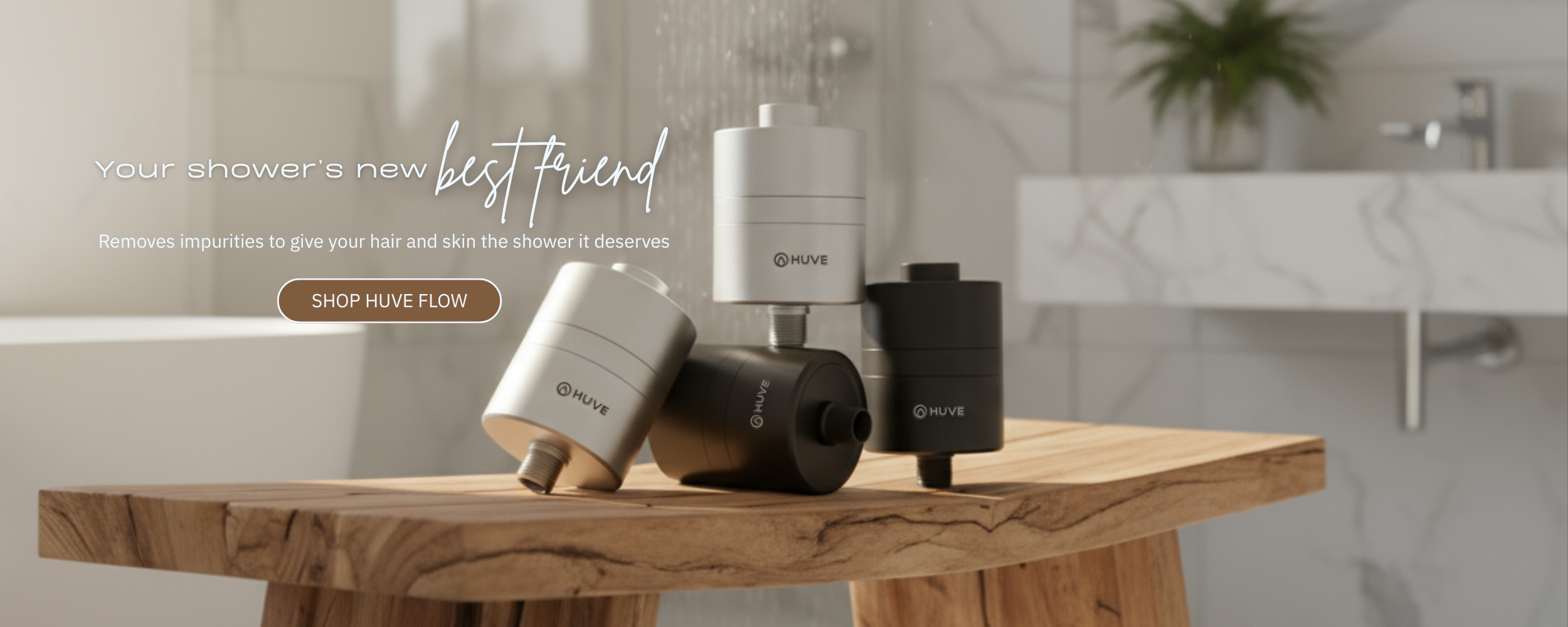 HUVE Flow shower filters on a wooden bench with a bathroom background