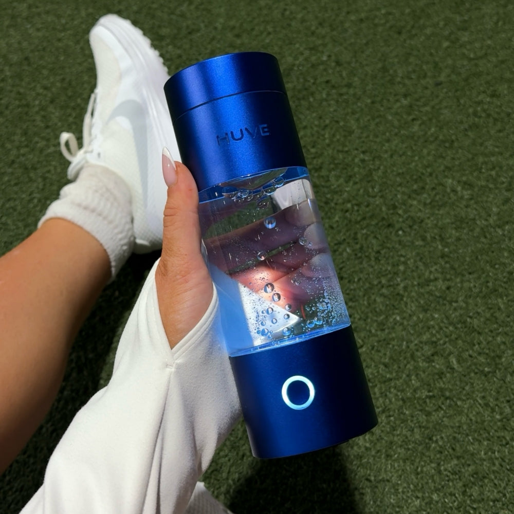 HUVE Perform hydrogen water bottle in cobalt blue shown in hand