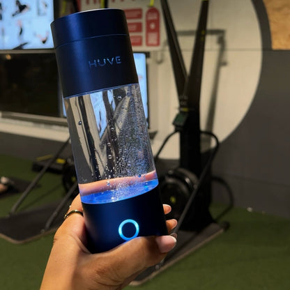 HUVE Perform hydrogen water bottle in cobalt blue shown at the gym 