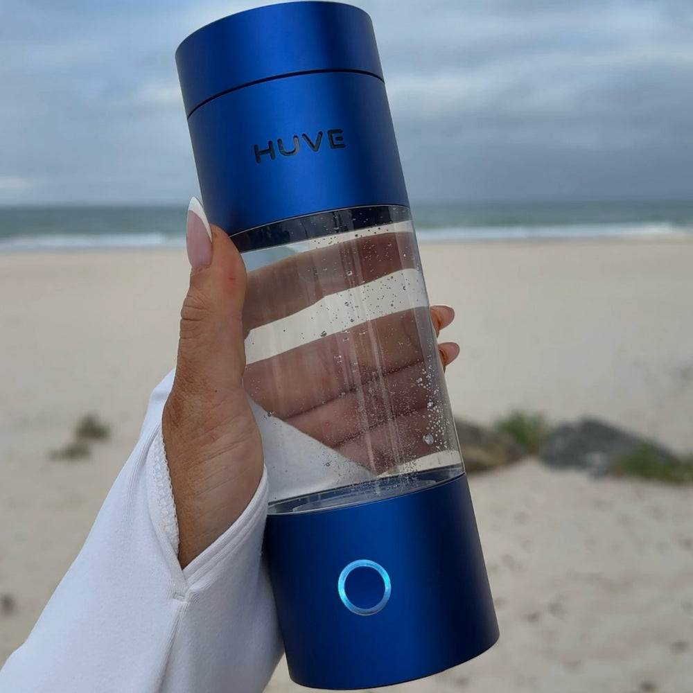 HUVE Perform hydrogen water bottle in cobalt blue shown at the beach