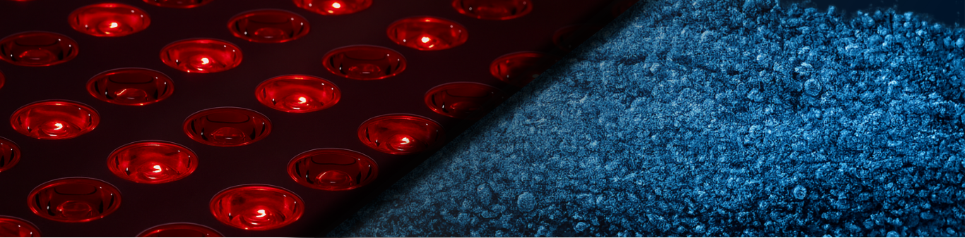 close up red light panel LEDs and fine water bubbles separated by a black border 