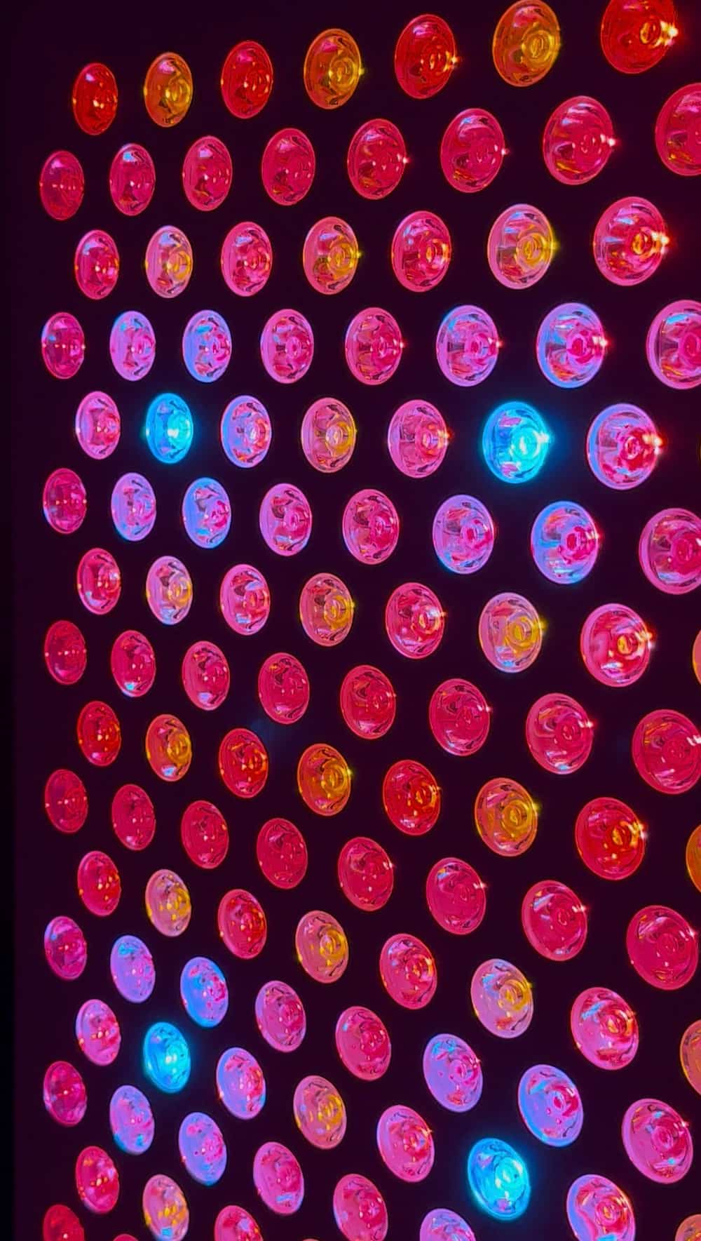 HUVE Luma red light therapy panel showing nine clinically calibrated LED wavelengths in operation