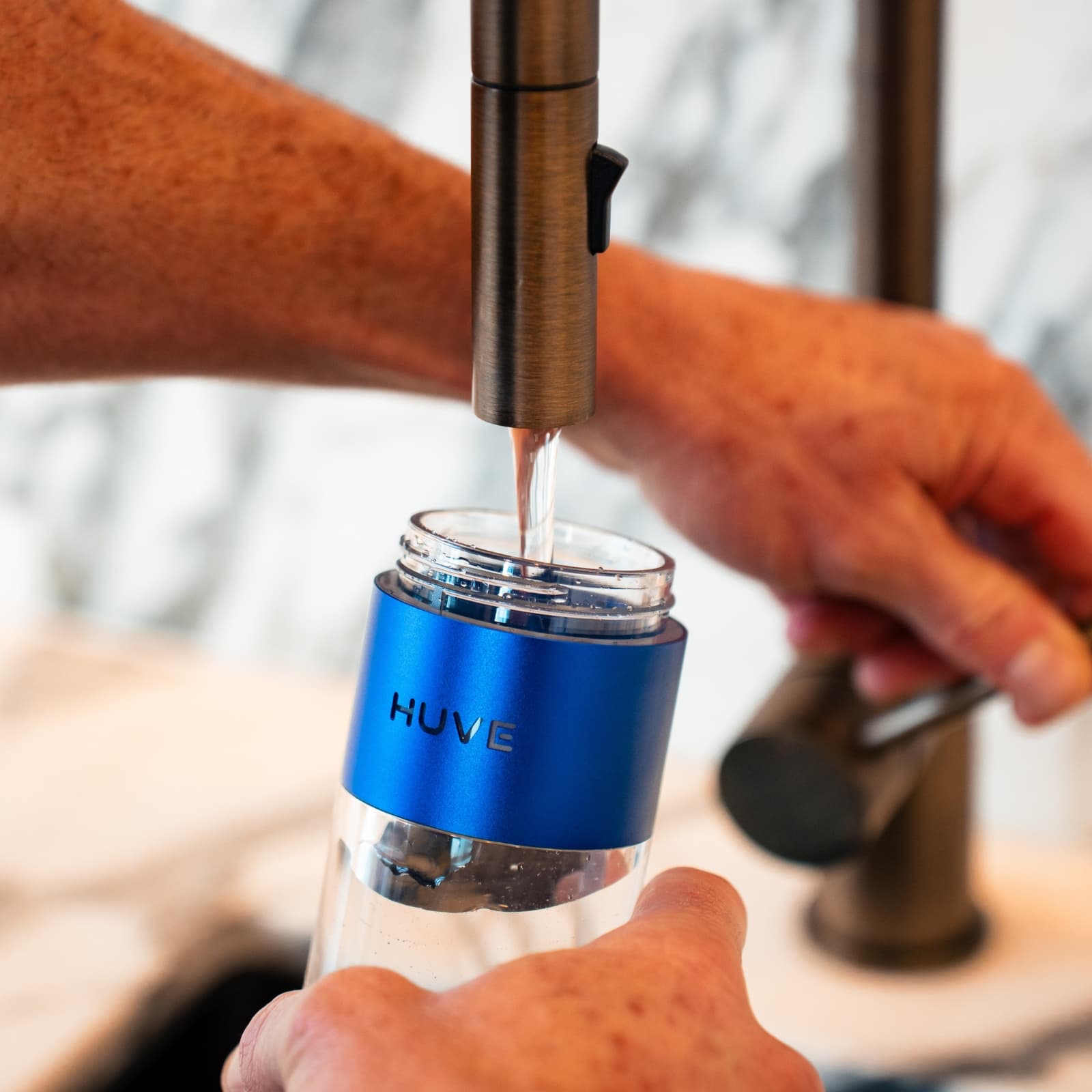 Filling a HUVE Perform hydrogen water bottle at a kitchen tap