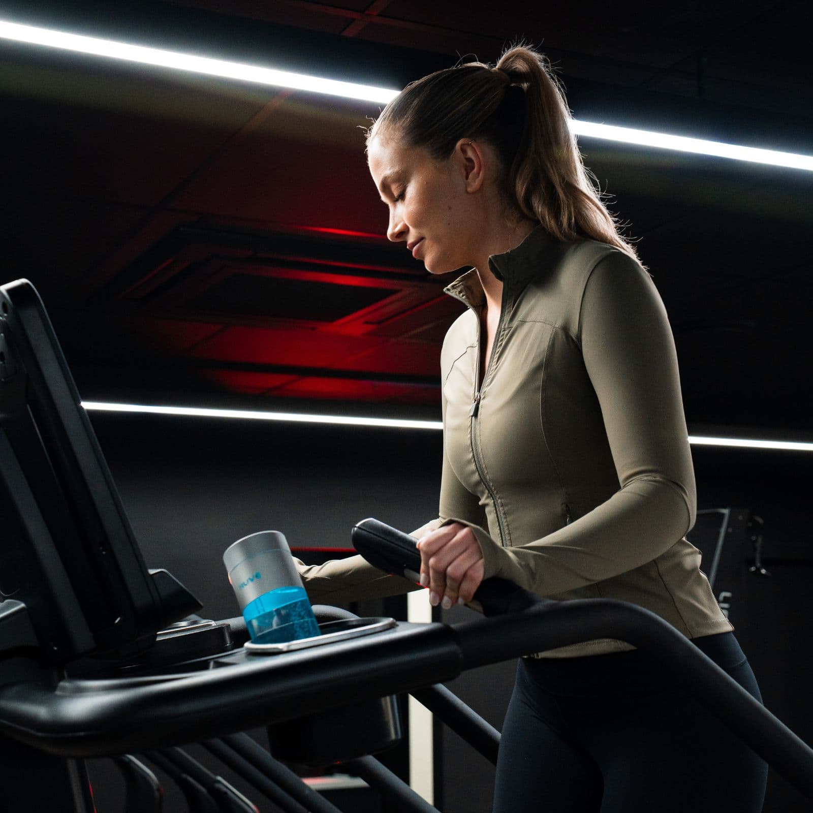 Woman on a treadmill with a HUVE Perform hydrogen water bottle