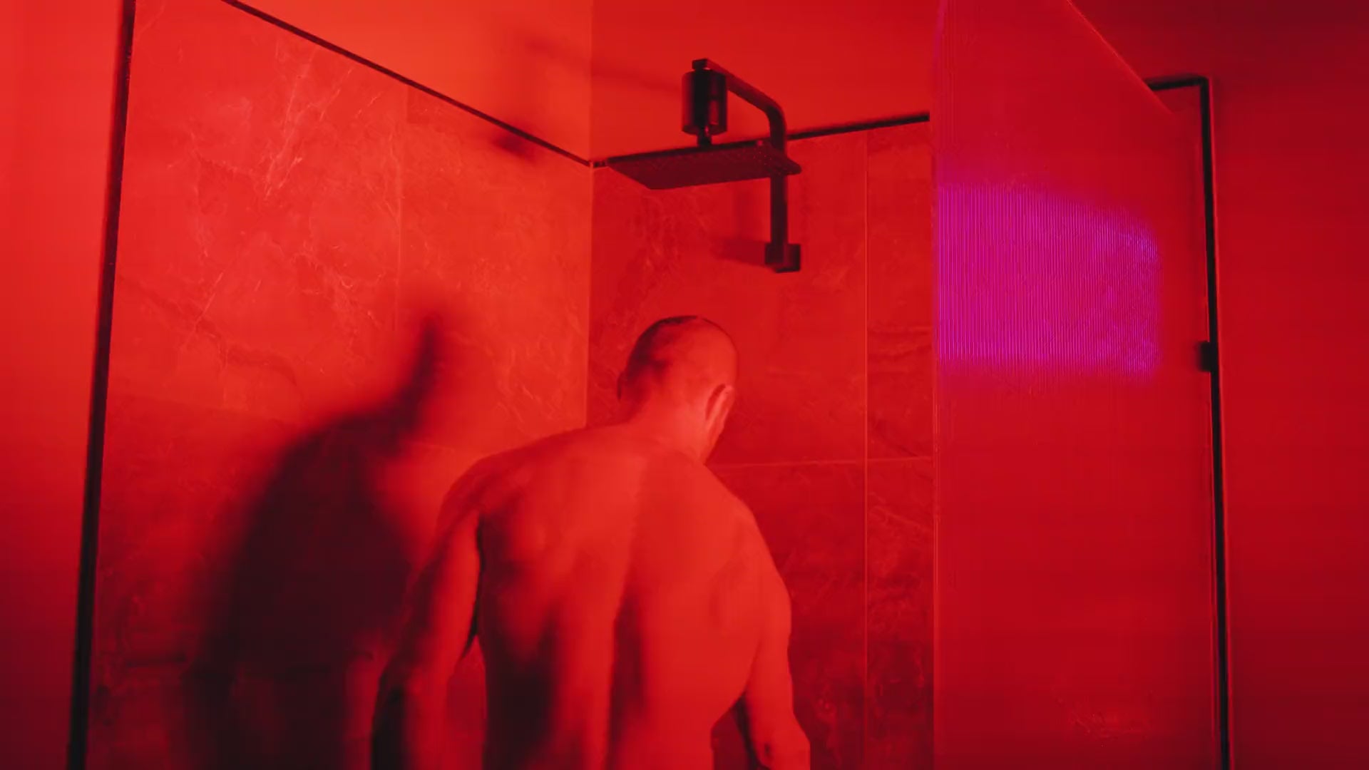 Man showering under a HUVE Flow shower filter